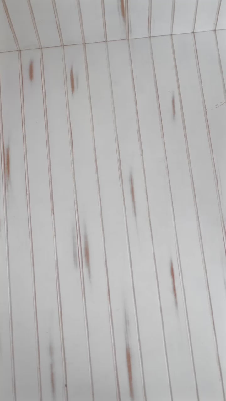 White wooden floor with vertical lines and subtle weathered texture.